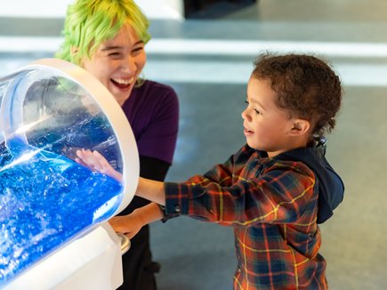 Child and science communicator with hands on science activity