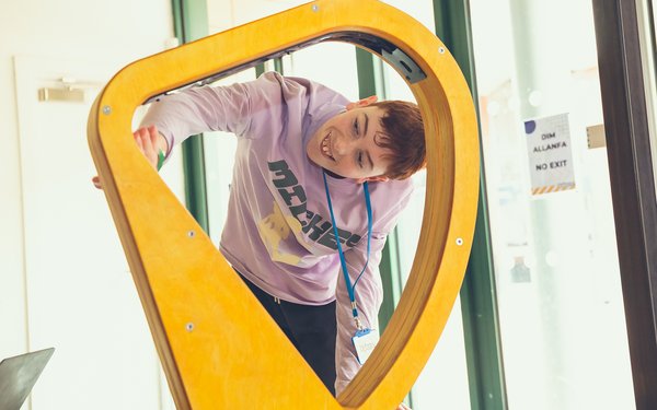 Young person engaging with interactive exhibit at Xplore! science centre, Wrexham
