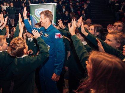 Astronaut Tim Peake surrounded by schoolchildren